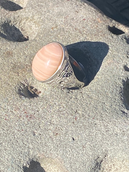 Natural Australian Pink Opal gemstone displaying distinctive color and polished finish