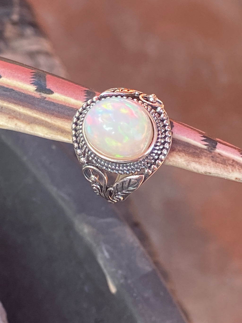 Natural 17-Carat Welo Opal Ring with Ornate Sterling Silver Setting gemstone ring, handcrafted jewelry featuring polished stone set in a decorative silver band
