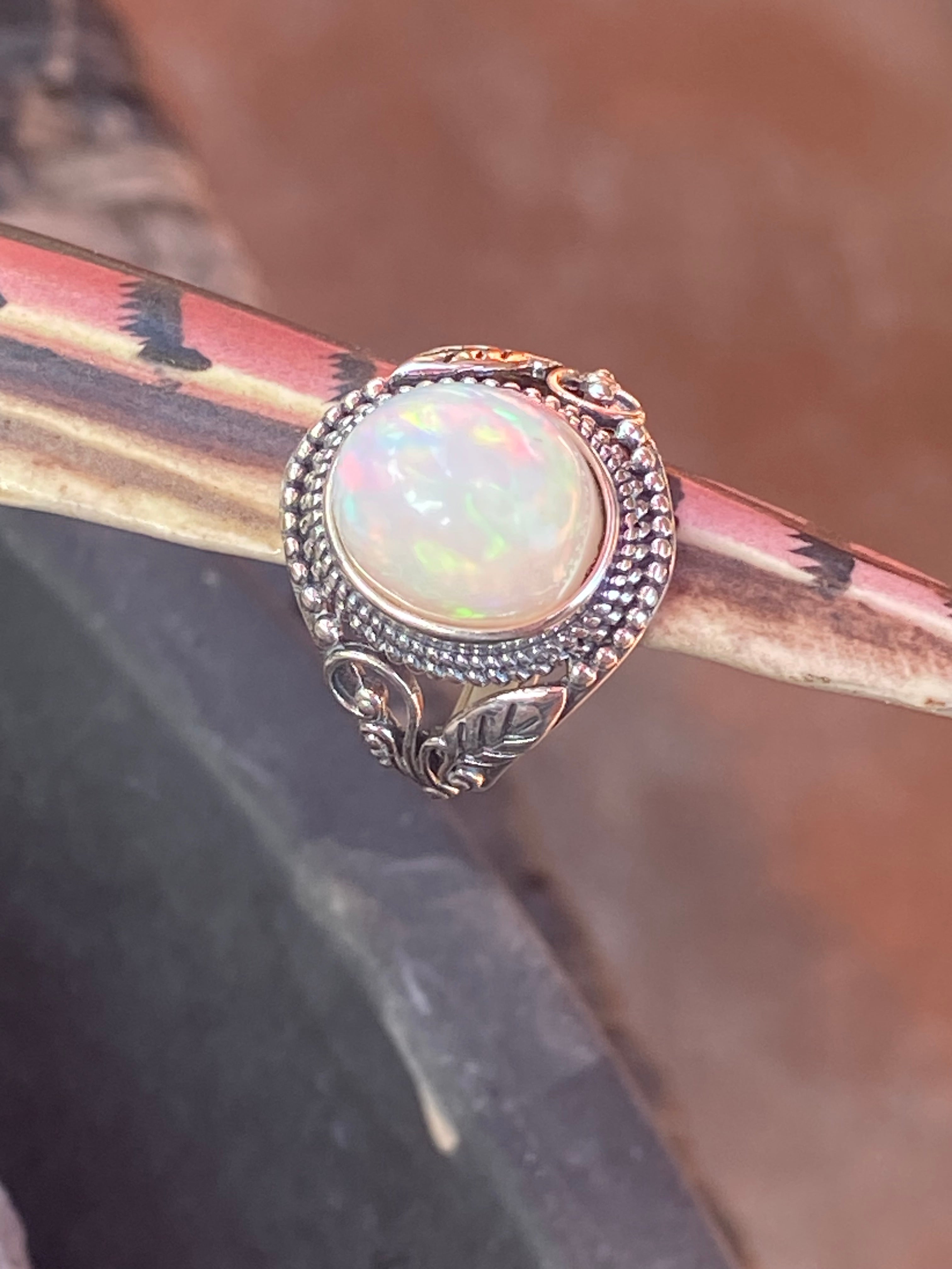 Natural 17-Carat Welo Opal Ring with Ornate Sterling Silver Setting gemstone ring, handcrafted jewelry featuring polished stone set in a decorative silver band