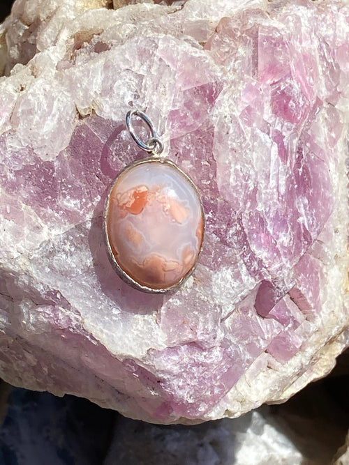 Pendant featuring Bubblegum Agate with pink, orange, silver tones showing cabochon, polished set in Sterling Silver.