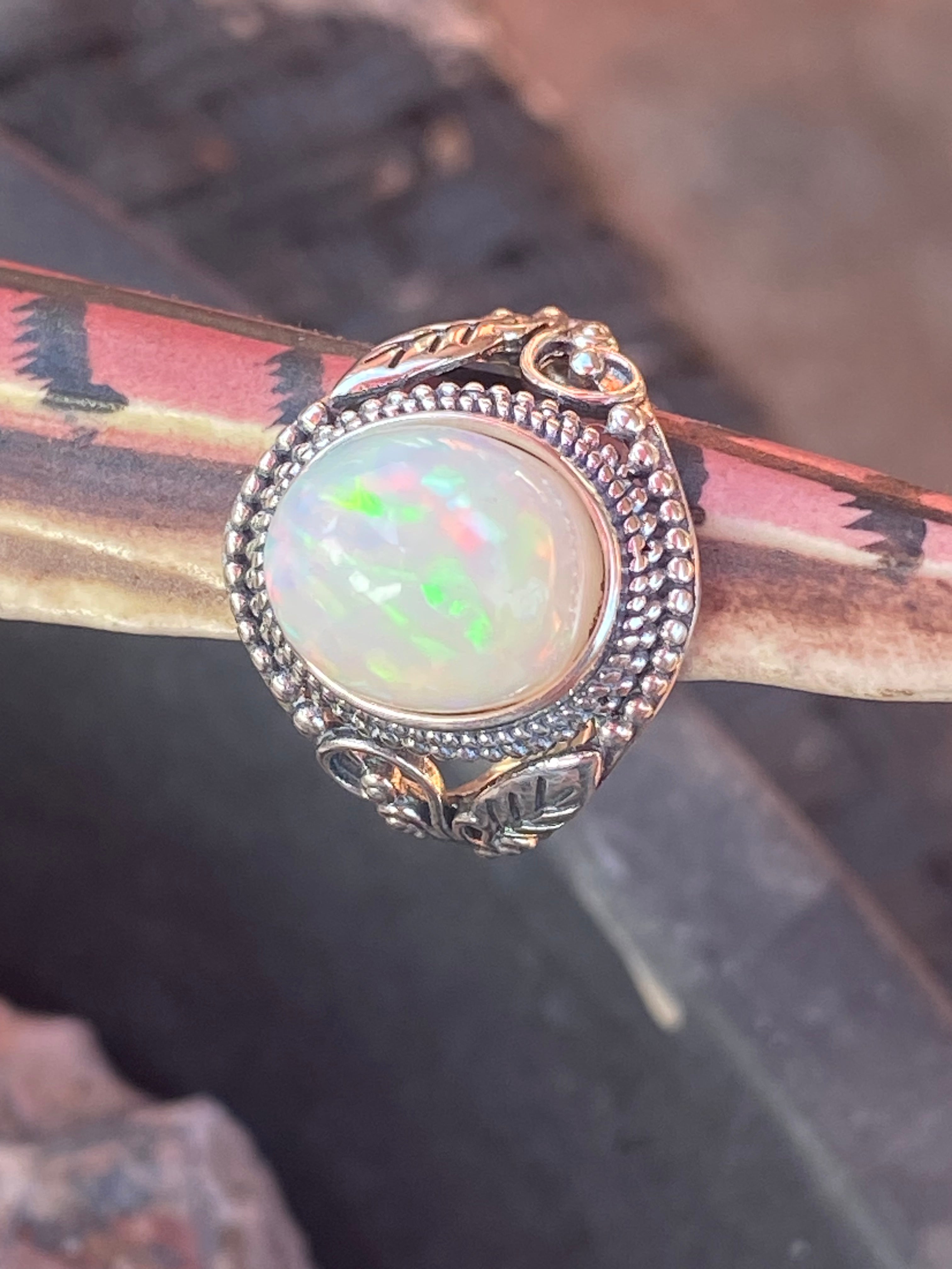 Natural 17-Carat Welo Opal Ring with Ornate Sterling Silver Setting gemstone ring, handcrafted jewelry featuring polished stone set in a decorative silver band