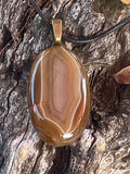 Natural Banded Agate Pendant gemstone pendant, handcrafted jewelry featuring polished stone with unique color and mineral patterns