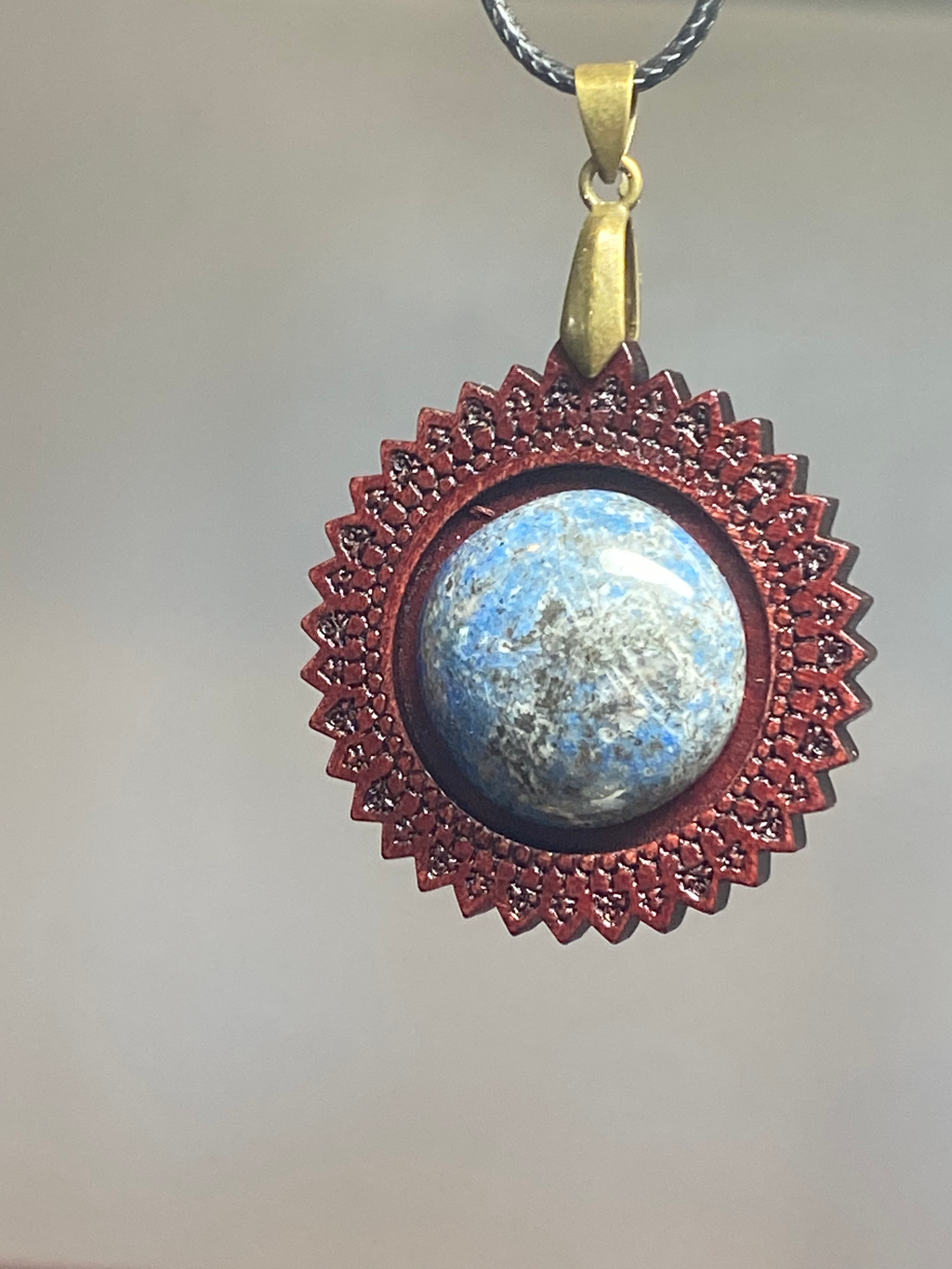 Natural Artisan Lapis Lazuli Pendant with Intricate Wooden Frame showcasing unique gemstone color and pattern in a handcrafted pendant