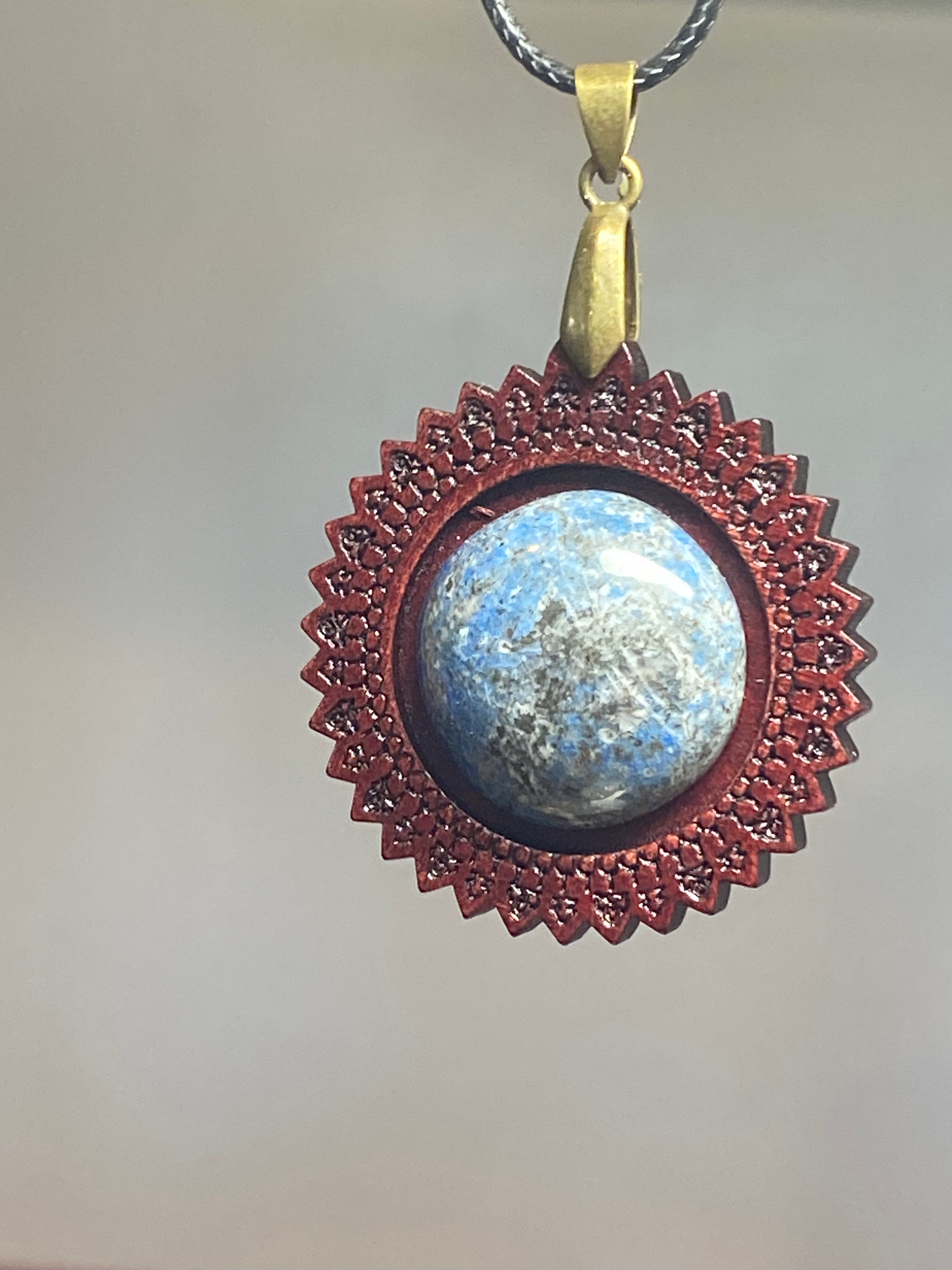 Natural Artisan Lapis Lazuli Pendant with Intricate Wooden Frame showcasing unique gemstone color and pattern in a handcrafted pendant