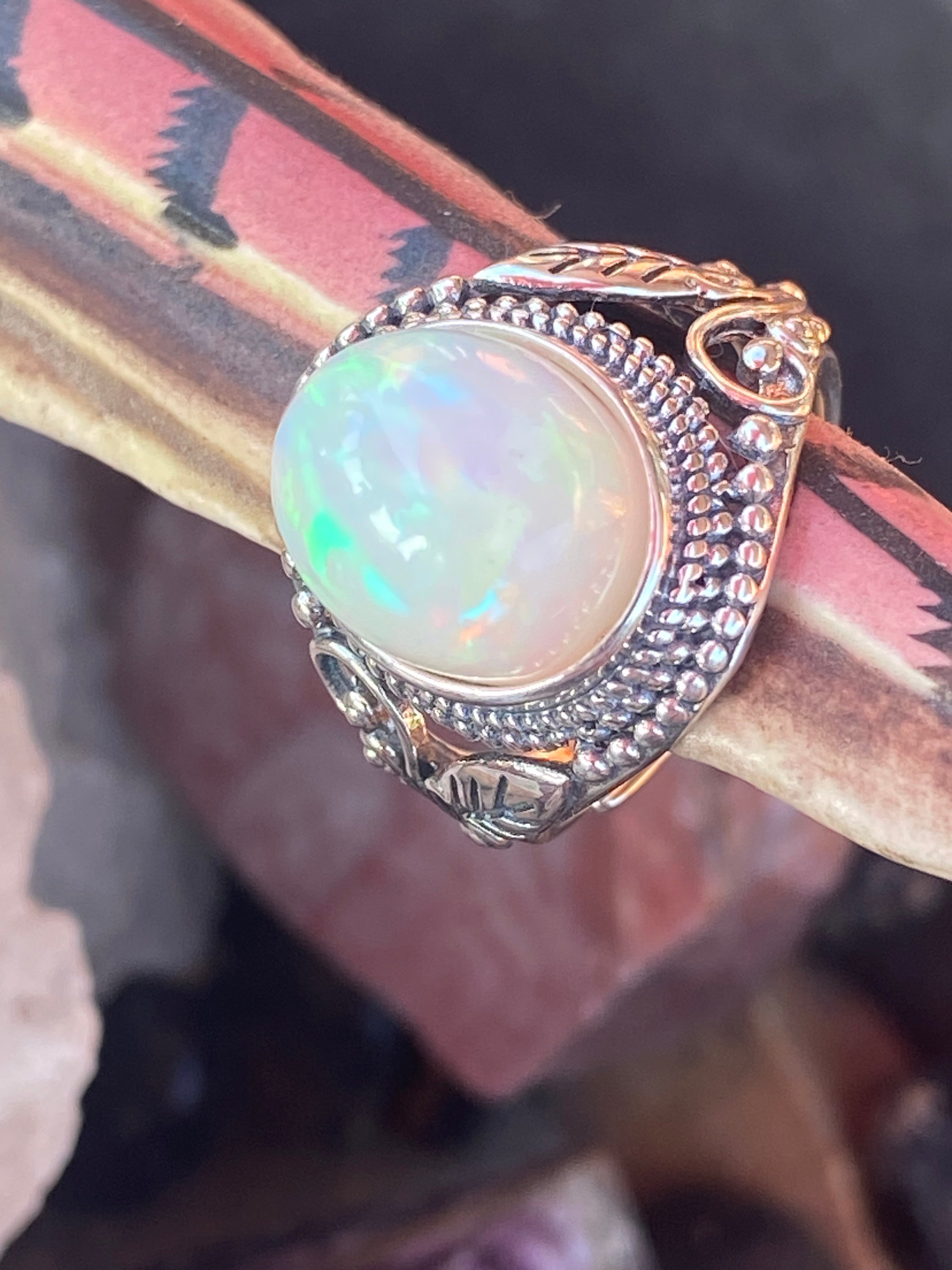 Natural 17-Carat Welo Opal Ring with Ornate Sterling Silver Setting gemstone ring, handcrafted jewelry featuring polished stone set in a decorative silver band